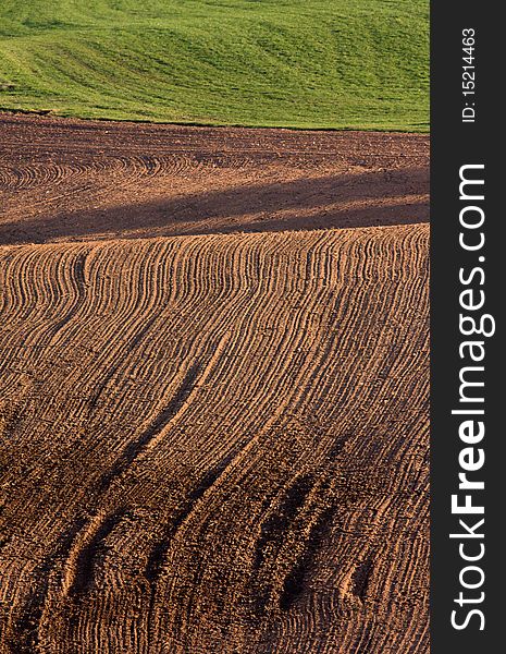 The freshly ploughed brown field. The freshly ploughed brown field