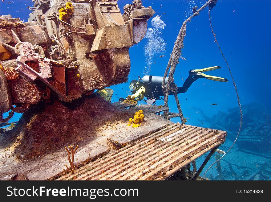 A female diver is exploring the superstructure of the sunken wreck, the Tibbetts, a Russian frigate that was sunk in the waters off Cayman Brac. A female diver is exploring the superstructure of the sunken wreck, the Tibbetts, a Russian frigate that was sunk in the waters off Cayman Brac.