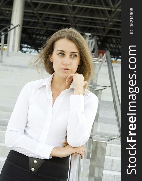 Contemporary portrait of a young professional business women to consider against the background of office space. Contemporary portrait of a young professional business women to consider against the background of office space