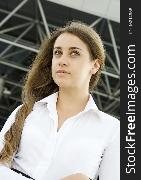 Contemporary portrait of a young professional business women to consider against the background of office space. Contemporary portrait of a young professional business women to consider against the background of office space