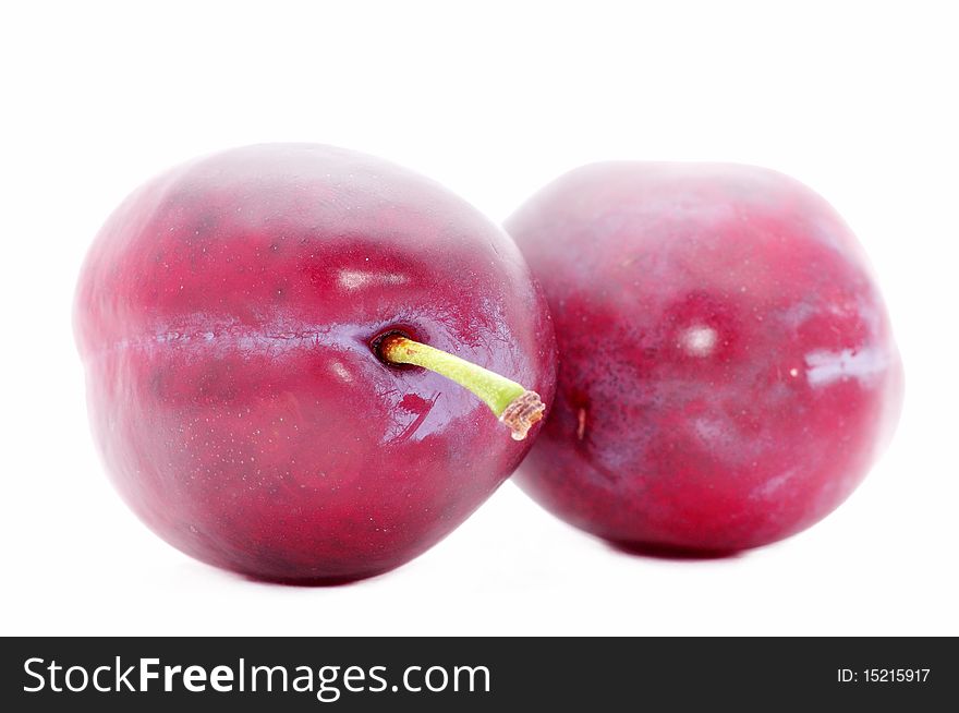 Two plums isolated over white