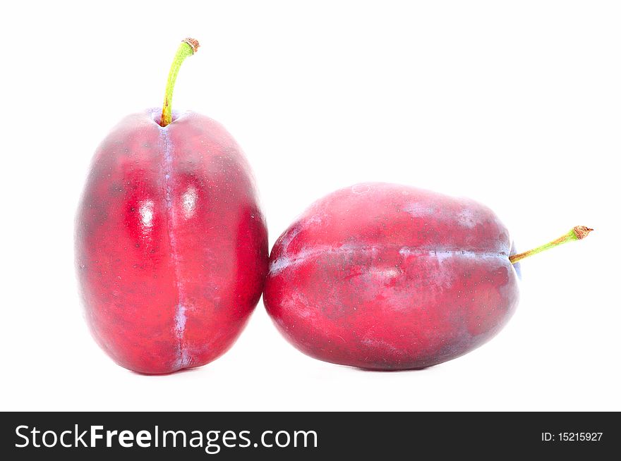 Two plums isolated over white