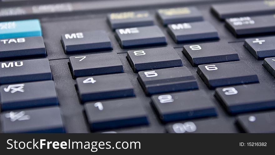 Closeup scene with black electronic calculator keyboard