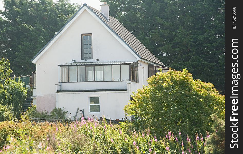 An image of a house being built with a sun room over the garage and workshop. An image of a house being built with a sun room over the garage and workshop.