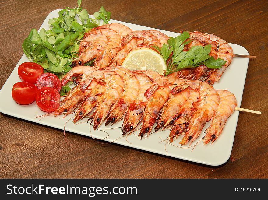 A dish with grilled shrimps