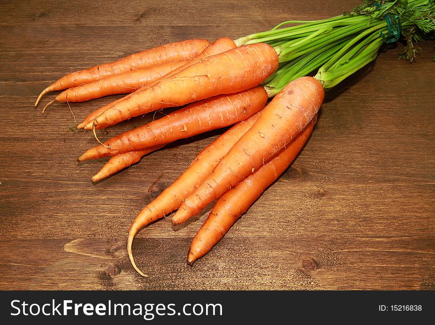 Fresh carrots on wooden table