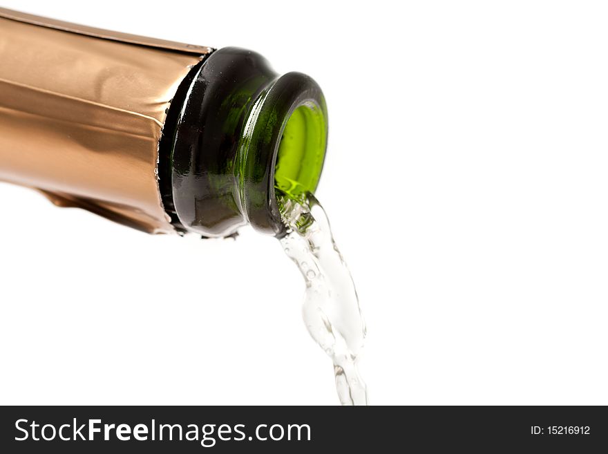 A macro shot of the top of a champagne bottle as champagne is poured out of it. Isolated on white. A macro shot of the top of a champagne bottle as champagne is poured out of it. Isolated on white.
