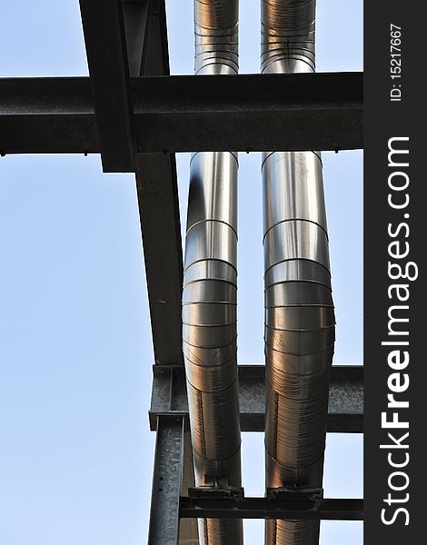 Two aluminium pipes make their way through  a maze of steel bars in the former Philips factoy area in Eindhoven. Two aluminium pipes make their way through  a maze of steel bars in the former Philips factoy area in Eindhoven