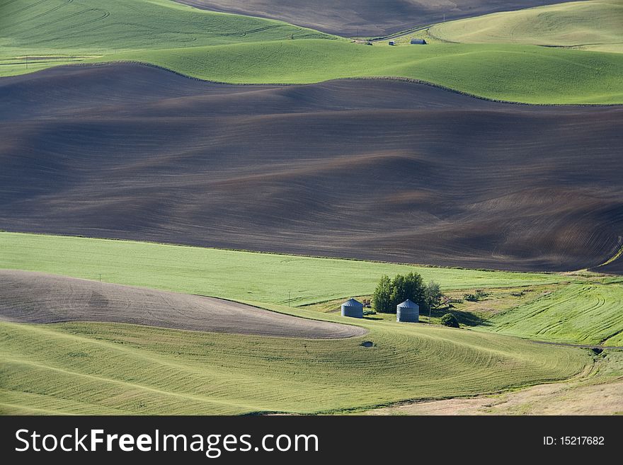 A farm is dwarfed by the vast size of the Palouse fields in eastern. A farm is dwarfed by the vast size of the Palouse fields in eastern