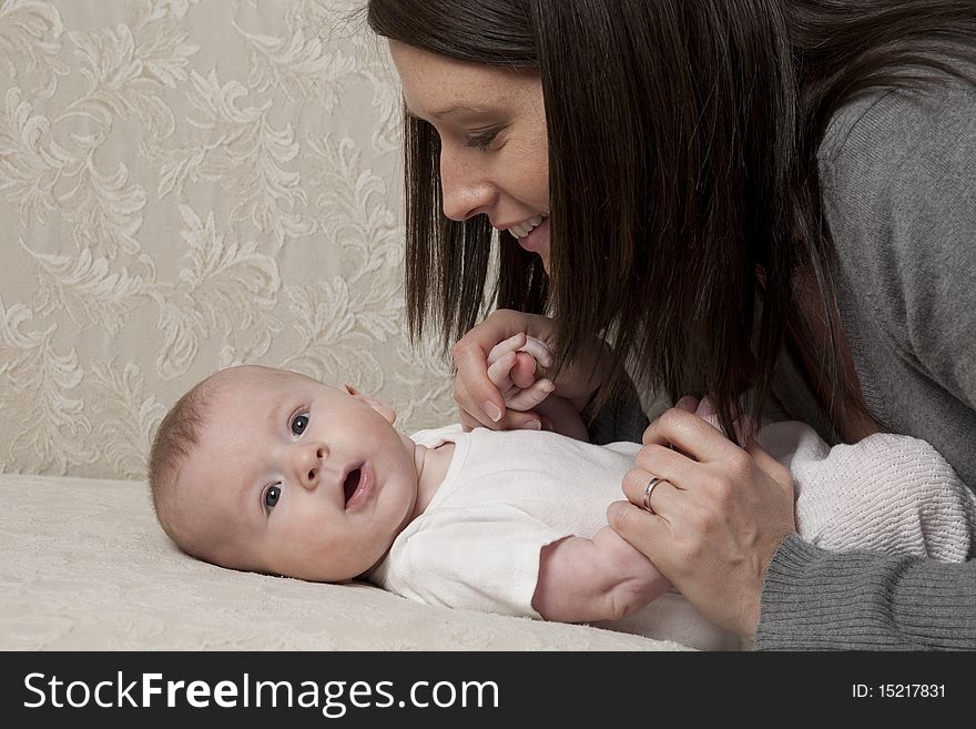 Horizontal image of a young mother leaning over her baby. Horizontal image of a young mother leaning over her baby