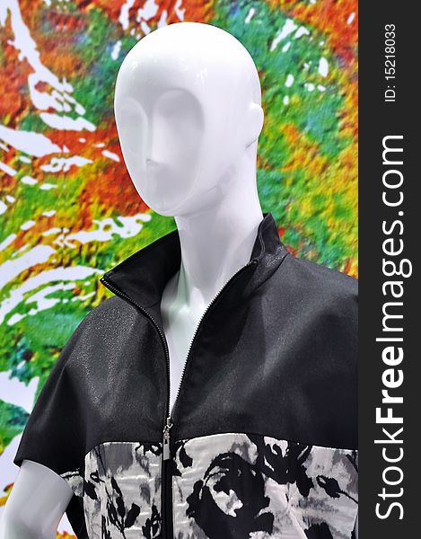 Mannequin in casual design clothing in white and black, in front of colorful background. Mannequin in casual design clothing in white and black, in front of colorful background.