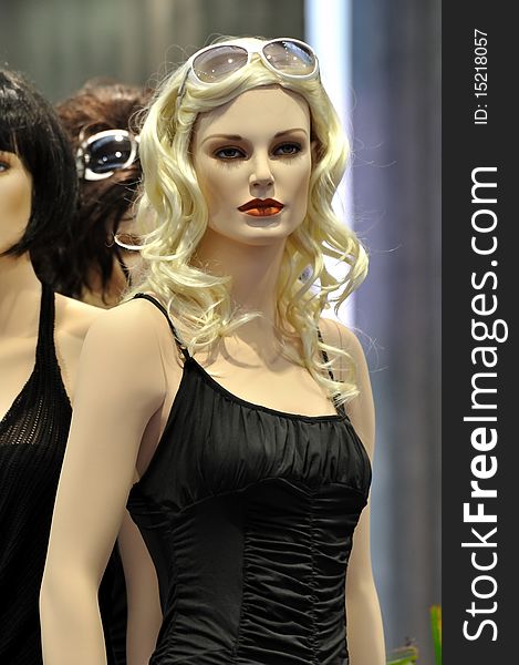 Beautiful female mannequin in fashion show, with casual and sexual design clothing in black.