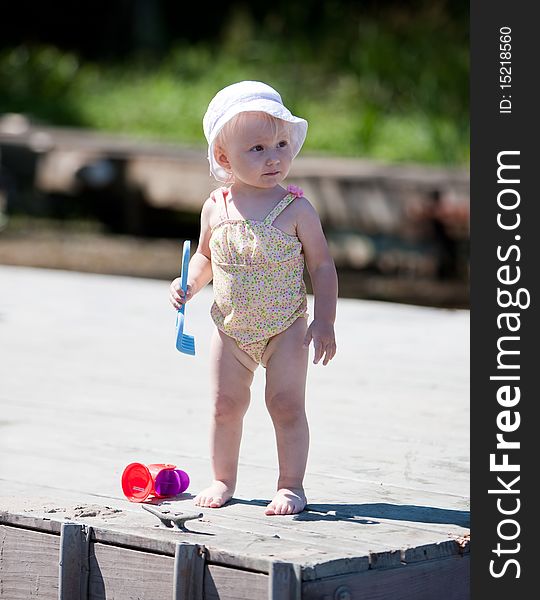 Image of the happy baby playing on the beach