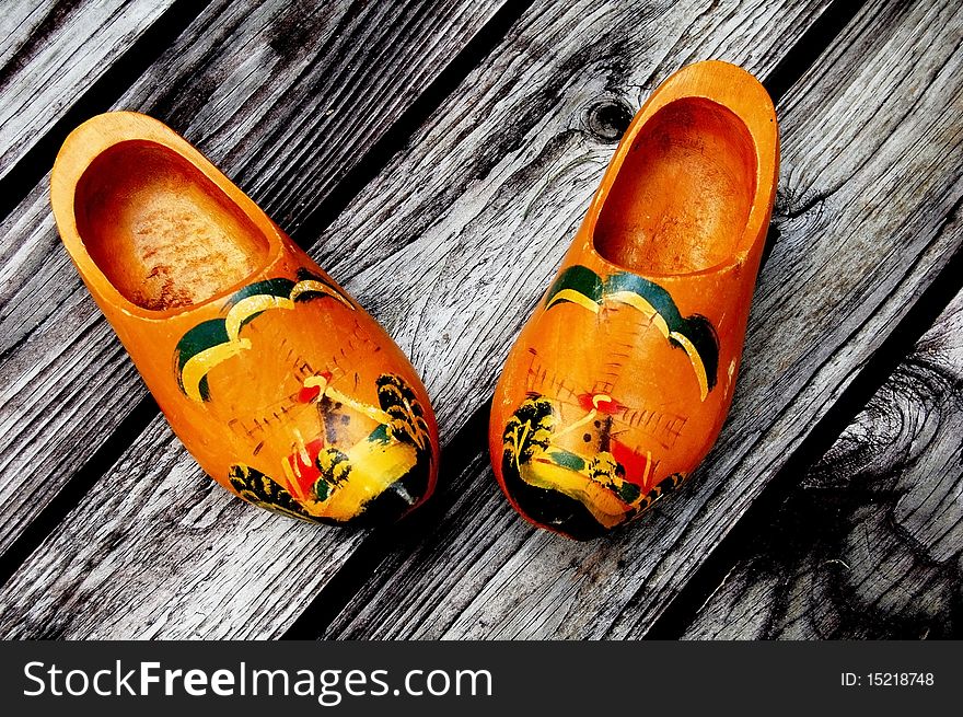 Traditional wooden holland clogs on wooden background