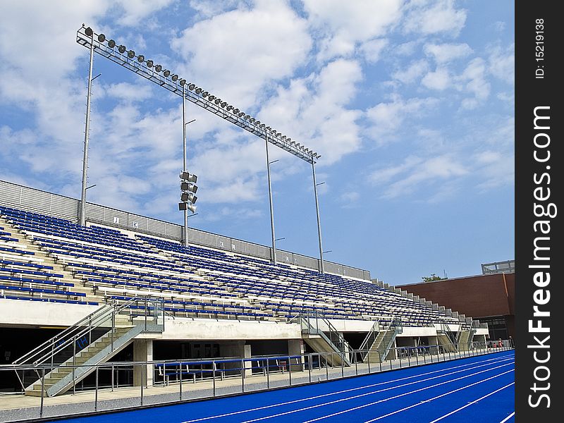 Stands and lighting in outdoor stadium shot on sunny day