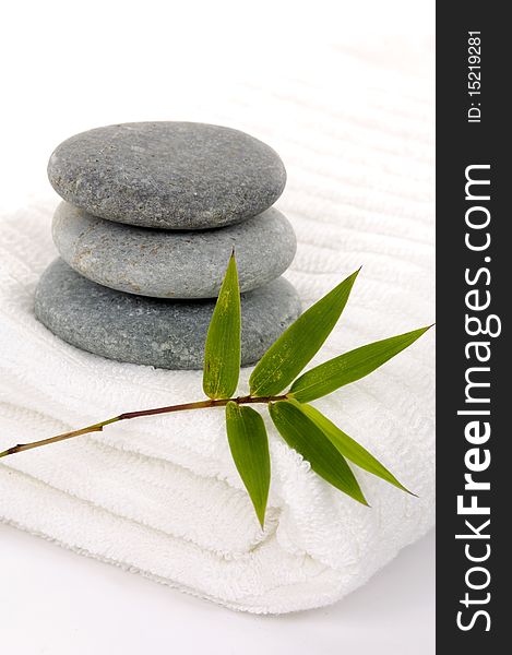 Zen stones with bamboo leaf on towel. Zen stones with bamboo leaf on towel
