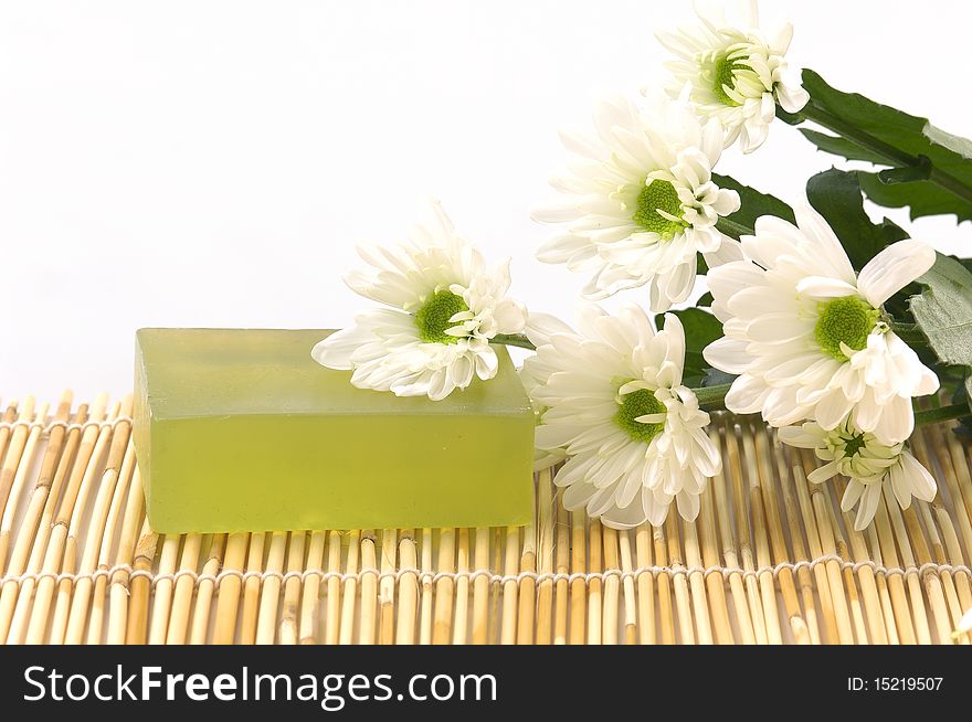 Spa object â€“white daisies flower and soap bars on mat. Spa object â€“white daisies flower and soap bars on mat