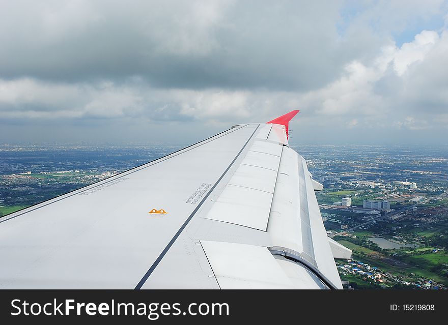 Travel view from airplane showing wing during flight over bangkok thailand. Travel view from airplane showing wing during flight over bangkok thailand