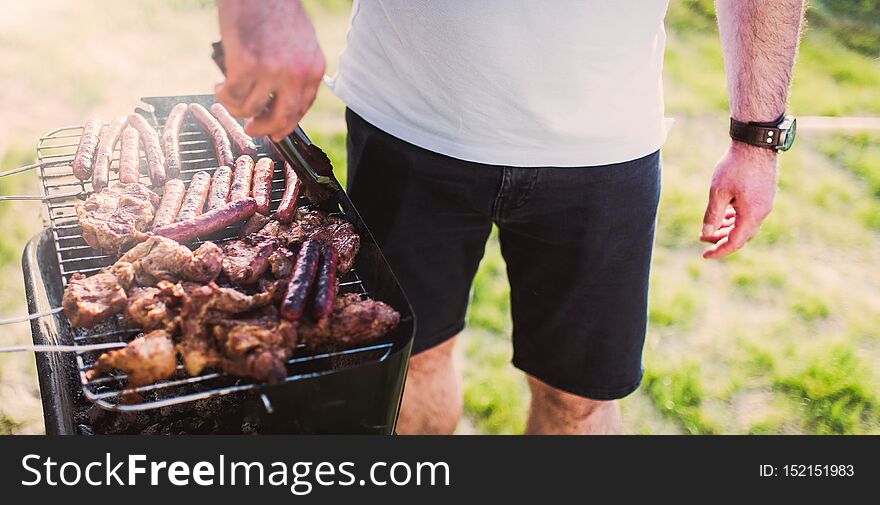 Grilling Sausages On Barbecue Grill.