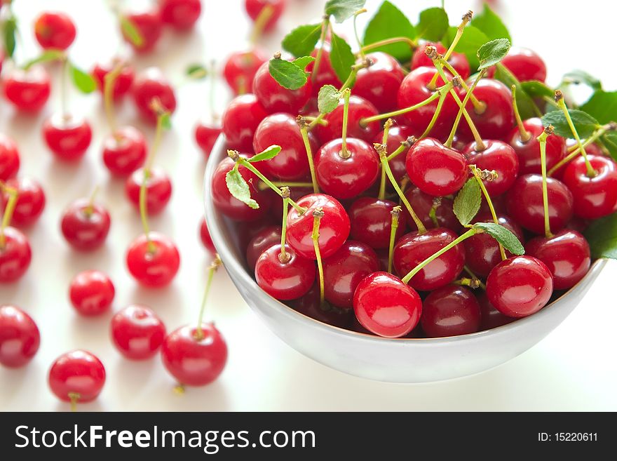 Cherries in a bowl on a white background