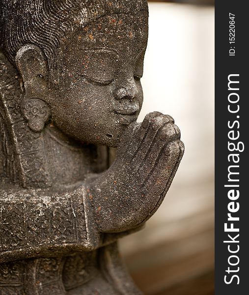 A side view of an ancient statue greeting in oriental style. A side view of an ancient statue greeting in oriental style.