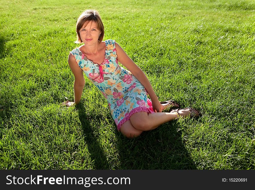 The girl having a rest on a grass in a sunny day. The girl having a rest on a grass in a sunny day