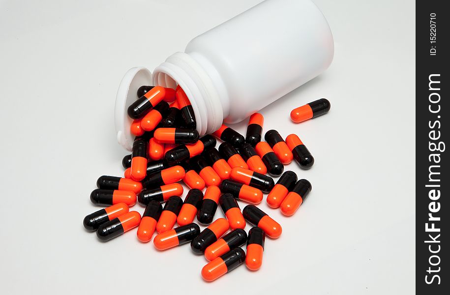 A pile of capsule on an isolated background. A pile of capsule on an isolated background.