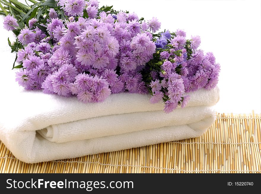 Towels with pink daisy on mat. Towels with pink daisy on mat