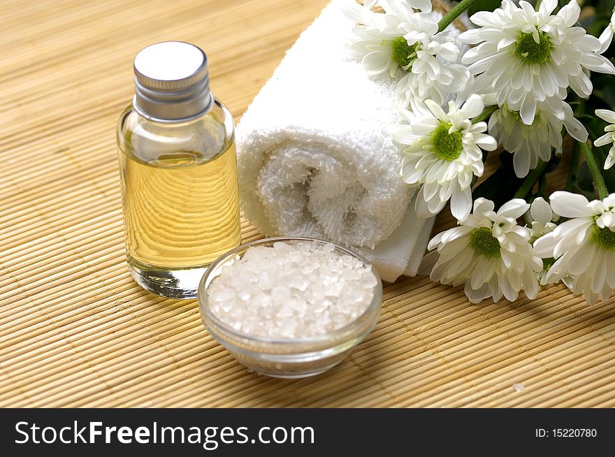 Spa composition. Towel, candle and chrysanthemums. Spa composition. Towel, candle and chrysanthemums