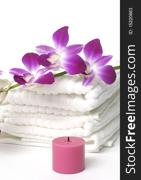 White towel and pink orchids flower and candle. White towel and pink orchids flower and candle
