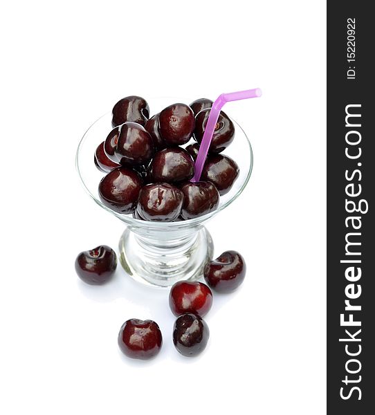 Delicious, ripe cherries in glass with drinking straw. Delicious, ripe cherries in glass with drinking straw