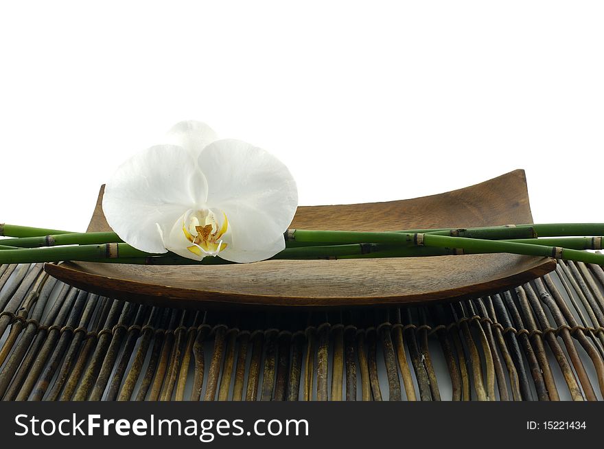Wooden bowl of orchid on mat. Wooden bowl of orchid on mat