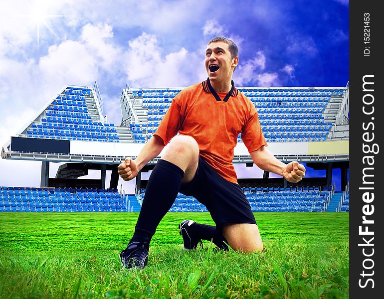 Happiness football player after goal on the field of stadium with blue sky. Happiness football player after goal on the field of stadium with blue sky