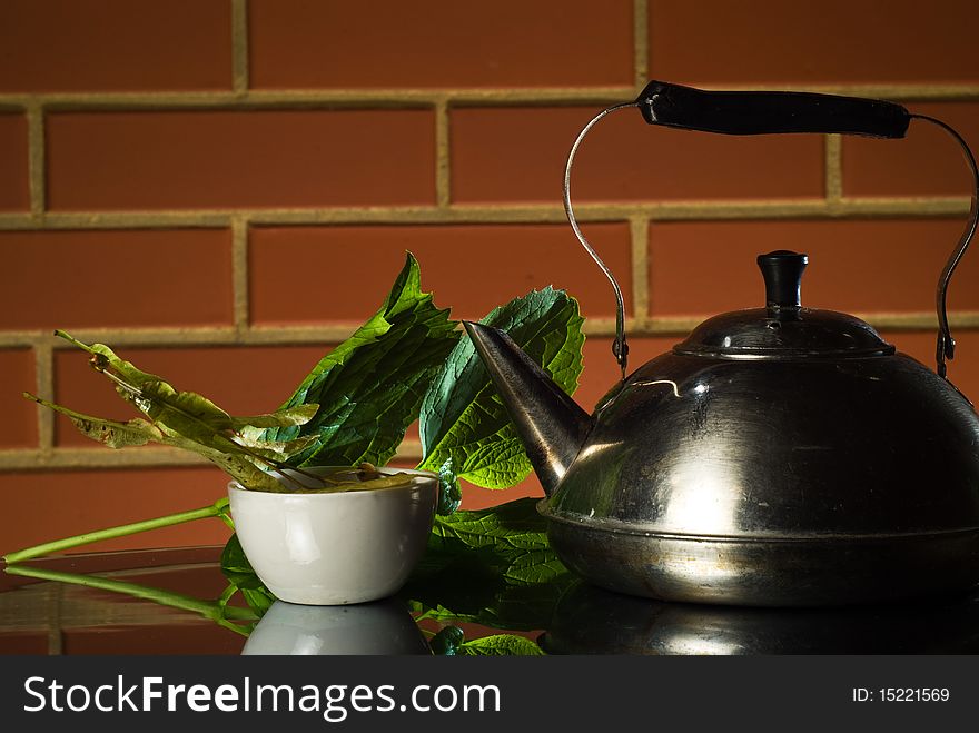 Metal teapot and lime buds tea