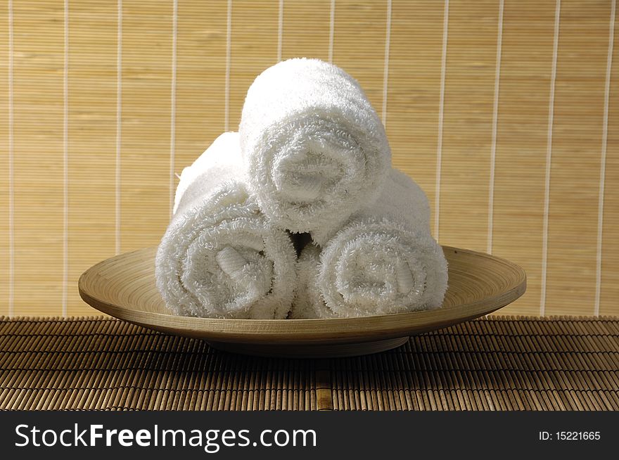 Wooden bowl towel on bamboo mat. Wooden bowl towel on bamboo mat
