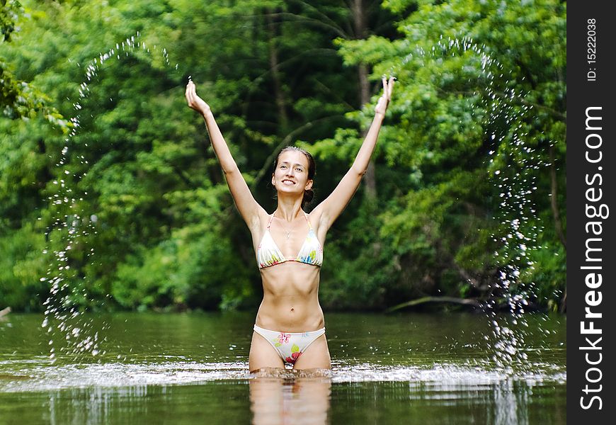 Young woman is splashing