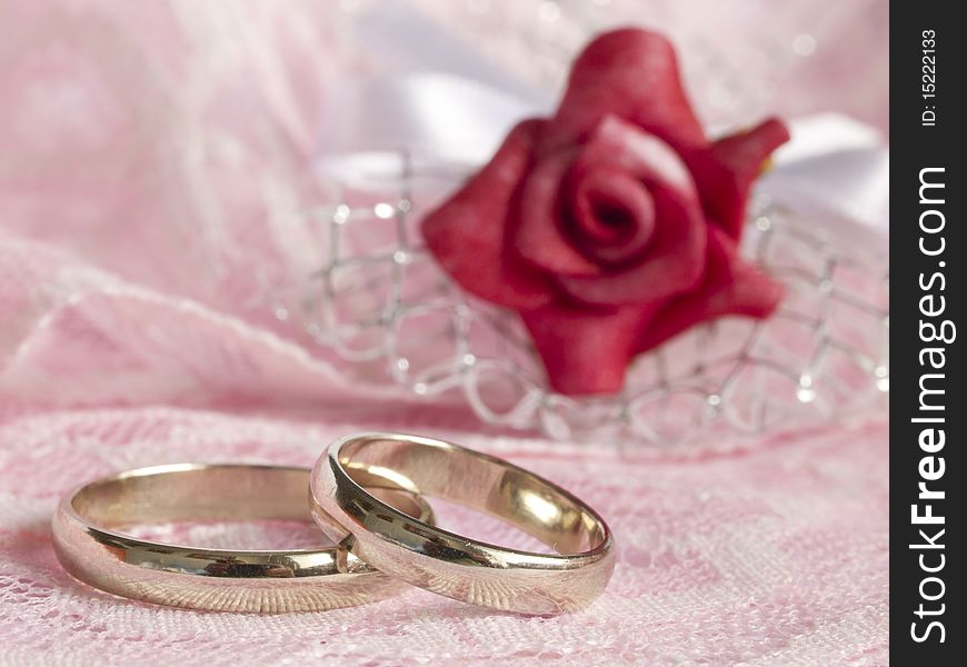 With white gold rings and red rose. With white gold rings and red rose