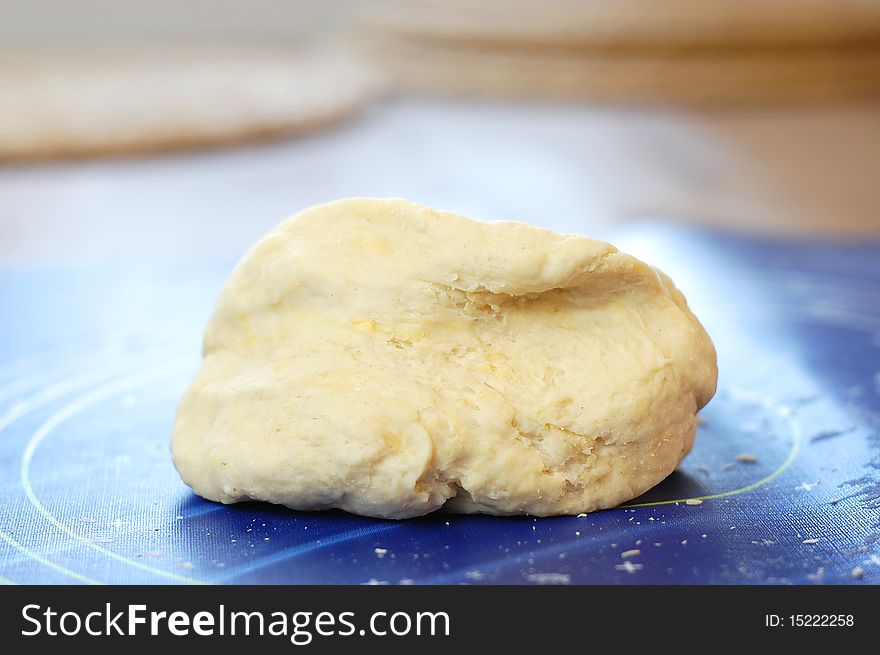 Dough ball on a blue pastry board