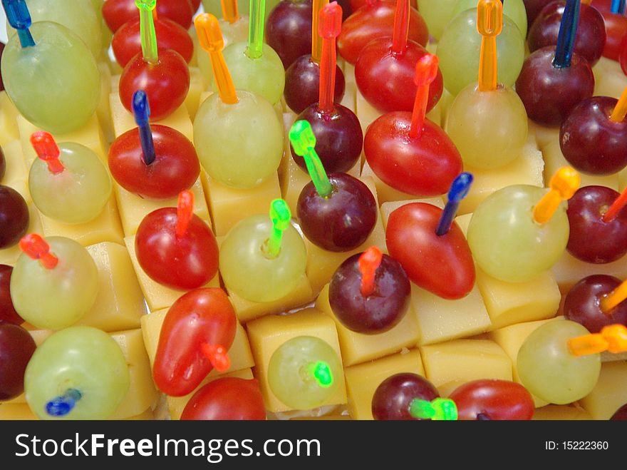 Cheese, cherry tomatoes and grapes served in a cocktail buffet. Cheese, cherry tomatoes and grapes served in a cocktail buffet