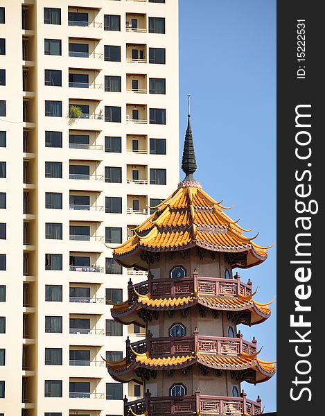 Bangkok - traditional and modern highrise with a blue sky background