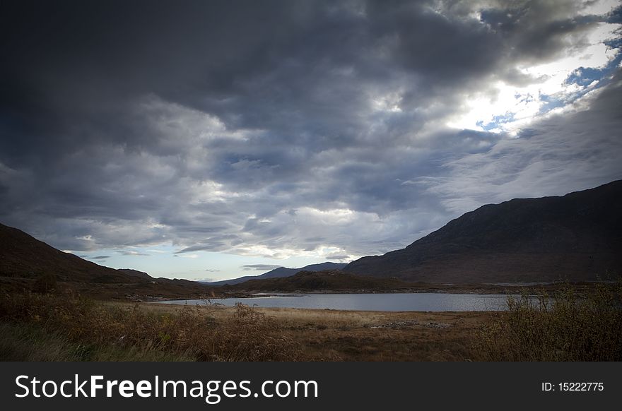 A loch with moody sky in the scottish highlands. A loch with moody sky in the scottish highlands