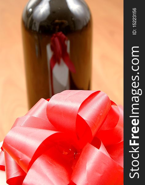 Red wine glass and gift box reflection