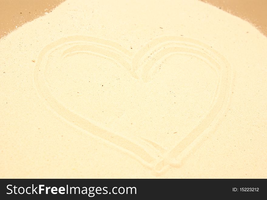 Heart shape on brown sand