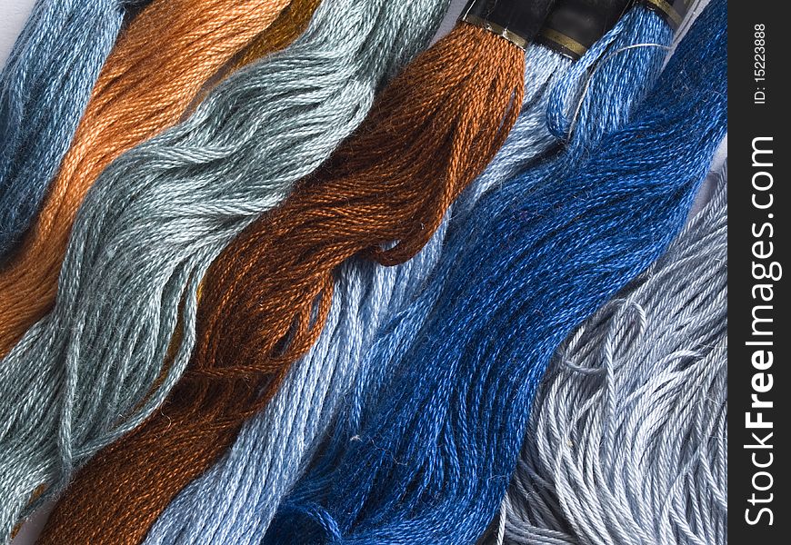 Blue, brown and orange yarns background. Blue, brown and orange yarns background