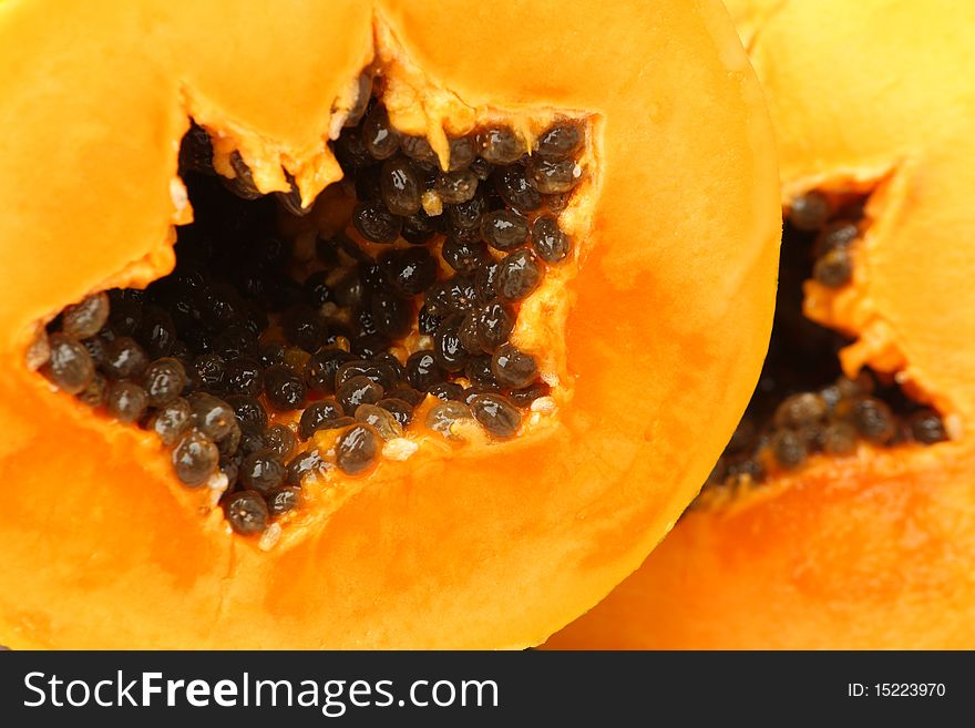 Close up of two colorful papaya slices