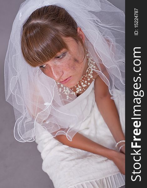 Sad bride on the ground - studio shot