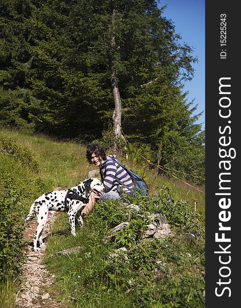 Boy with Dalmatian dog on a mountain hiking trail. Boy with Dalmatian dog on a mountain hiking trail