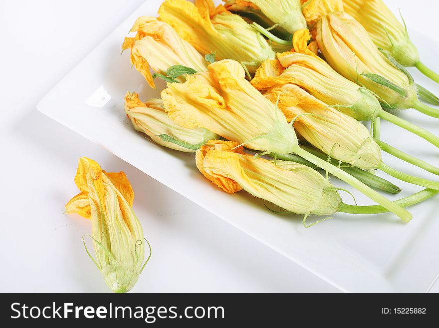 Shot of a plate of fresh squash blossoms from the market