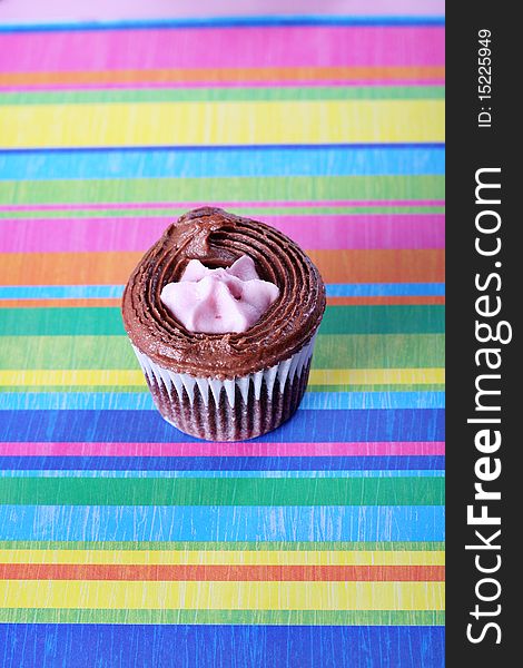 Shot of raspberry filled cupcake on colorful background