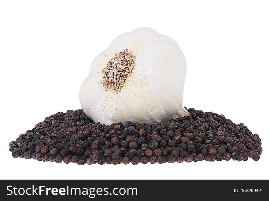 Black pepper and garlic - spices for many dishes on a white background.